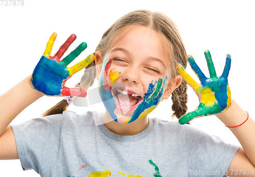 Image of Portrait of a cute girl playing with paints