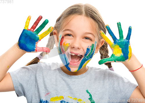 Image of Portrait of a cute girl playing with paints