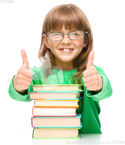 Image of Little girl is reading a book