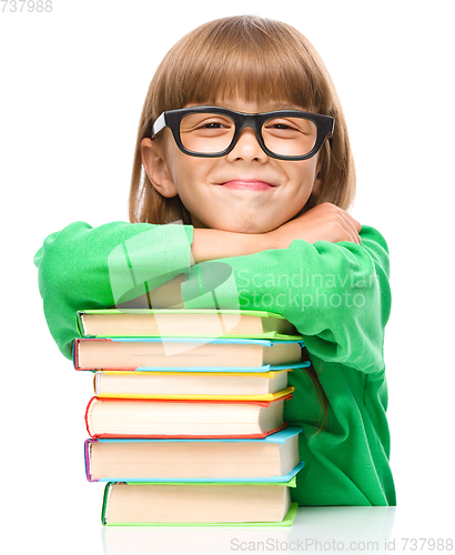 Image of Little girl with a pile of books