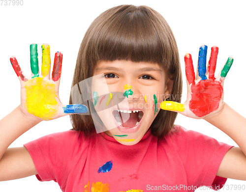 Image of Portrait of a cute girl playing with paints