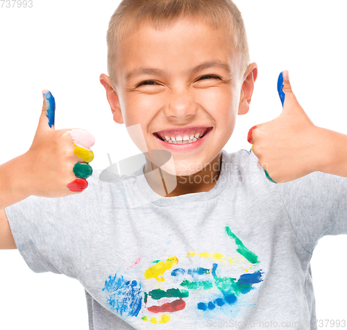 Image of Portrait of a cute boy playing with paints