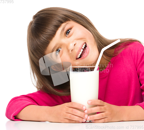 Image of Cute little girl with a glass of milk