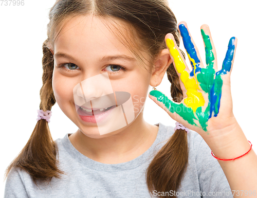 Image of Portrait of a cute girl playing with paints