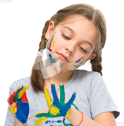 Image of Portrait of a cute girl playing with paints