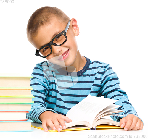 Image of Little boy is reading a book