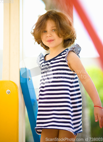 Image of Cute little girl is playing in playground