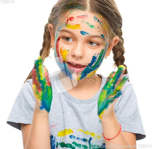 Image of Portrait of a cute girl playing with paints