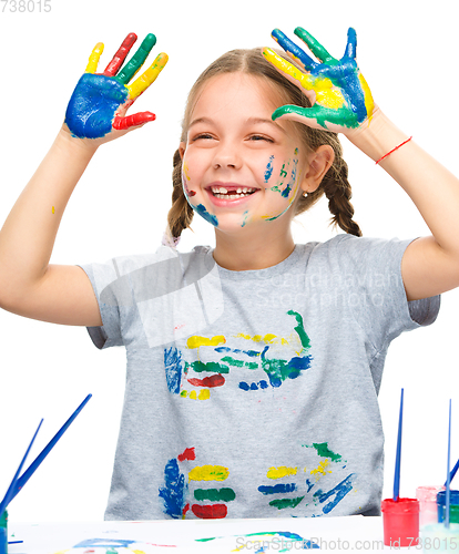 Image of Portrait of a cute girl playing with paints