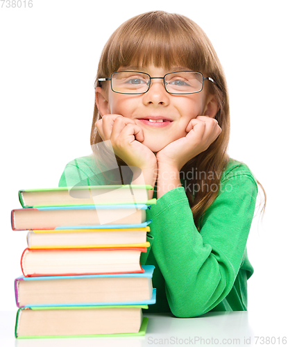Image of Little girl with a pile of books