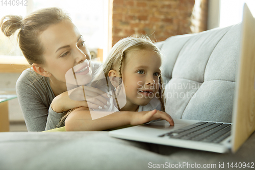 Image of Teacher and little girl, or mom and daughter. Homeschooling concept