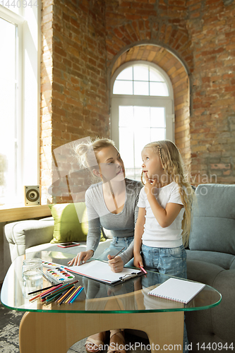 Image of Teacher and little girl, or mom and daughter. Homeschooling concept