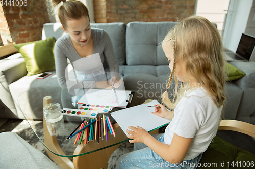 Image of Teacher and little girl, or mom and daughter. Homeschooling concept