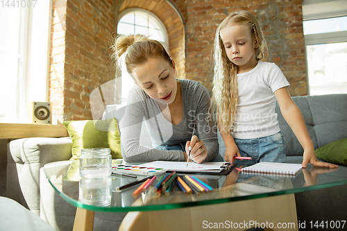 Image of Teacher and little girl, or mom and daughter. Homeschooling concept