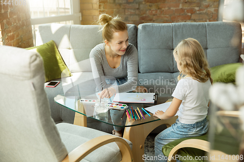 Image of Teacher and little girl, or mom and daughter. Homeschooling concept