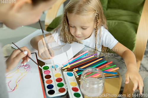 Image of Teacher and little girl, or mom and daughter. Homeschooling concept