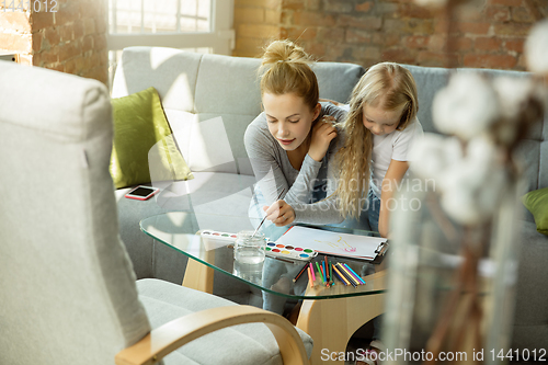 Image of Teacher and little girl, or mom and daughter. Homeschooling concept