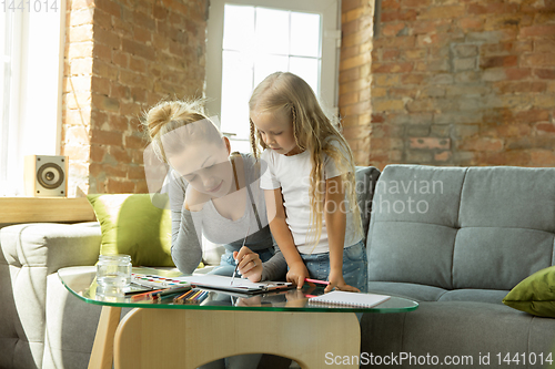 Image of Teacher and little girl, or mom and daughter. Homeschooling concept