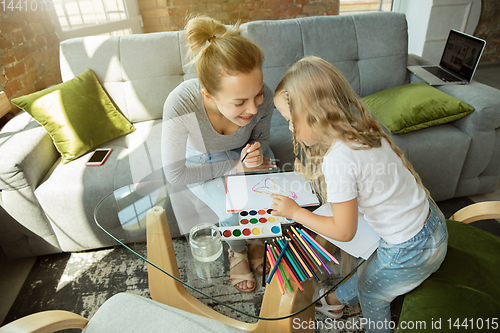 Image of Teacher and little girl, or mom and daughter. Homeschooling concept