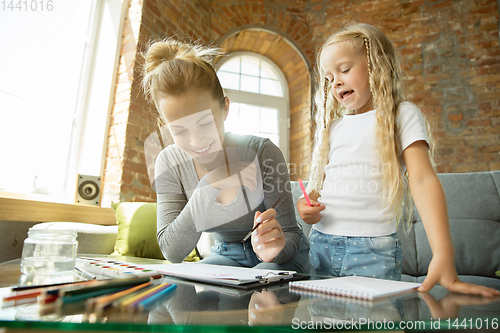 Image of Teacher and little girl, or mom and daughter. Homeschooling concept