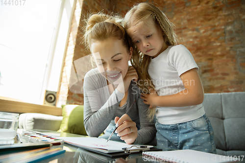 Image of Teacher and little girl, or mom and daughter. Homeschooling concept