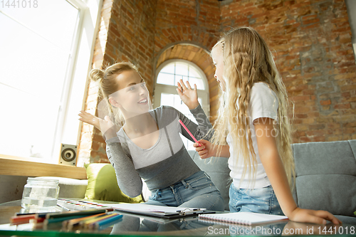 Image of Teacher and little girl, or mom and daughter. Homeschooling concept