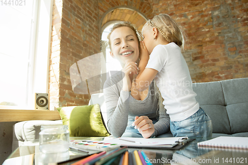 Image of Teacher and little girl, or mom and daughter. Homeschooling concept