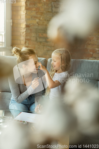 Image of Teacher and little girl, or mom and daughter. Homeschooling concept