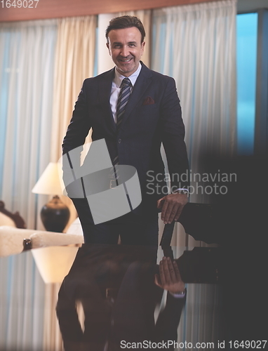 Image of Portrait of smiling ceo at modern office in stylish suit