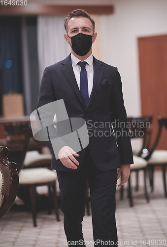 Image of business man wearing protective face mask at office