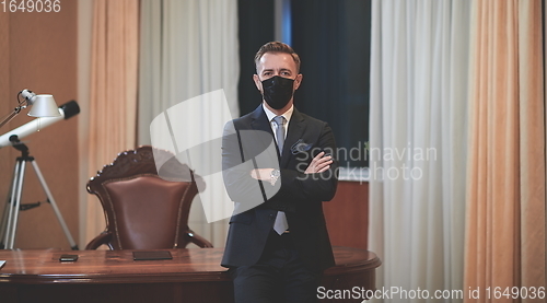 Image of business man wearing protective face mask at office