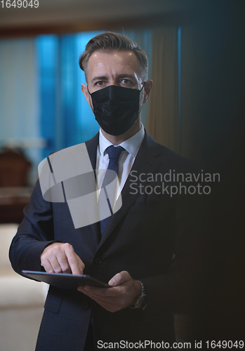 Image of business man wearing protective face mask at office