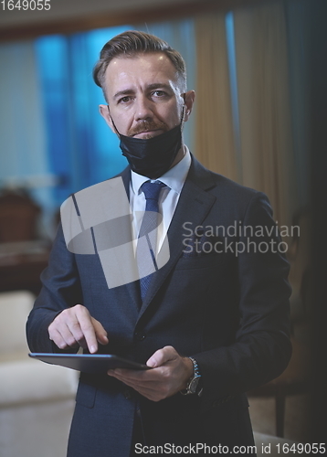 Image of business man wearing protective face mask at office