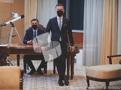 Image of business team wearing crona virus protection face mask
