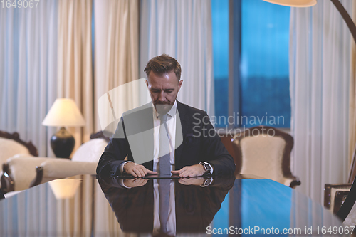 Image of business man using tablet computer