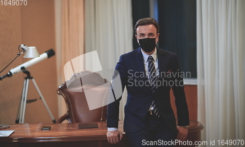 Image of business man wearing protective face mask at office