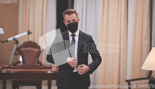 Image of business man wearing protective face mask at office