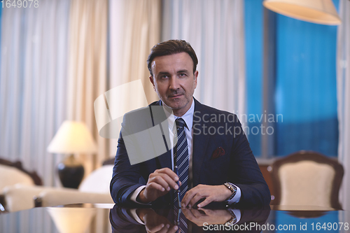 Image of corporate businessman at luxury office pen holding 