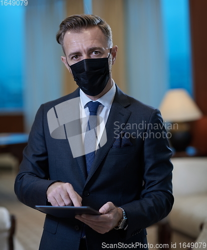 Image of business man wearing protective face mask at office