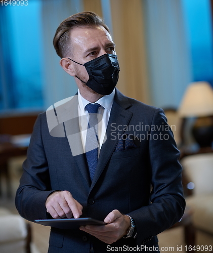 Image of business man wearing protective face mask at office