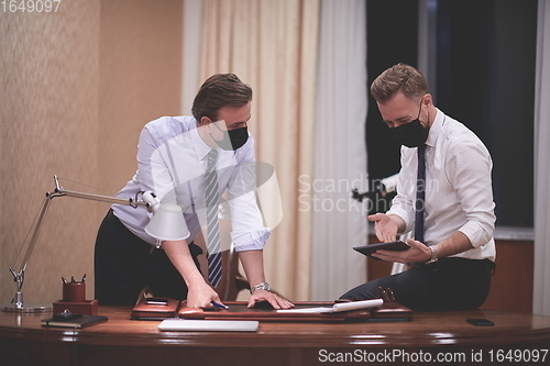 Image of business people wearing crona virus protection face mask on meeting