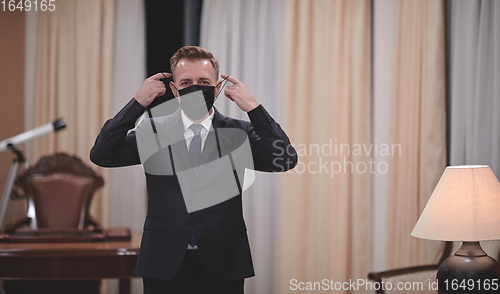 Image of business man wearing protective face mask at office