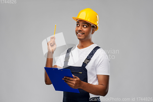 Image of builder with clipboard and pencil having idea