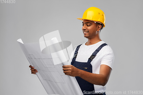 Image of happy indian builder in helmet with blueprint