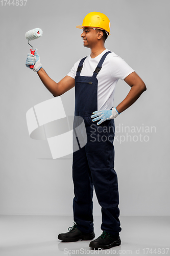 Image of happy indian painter or builder with paint roller