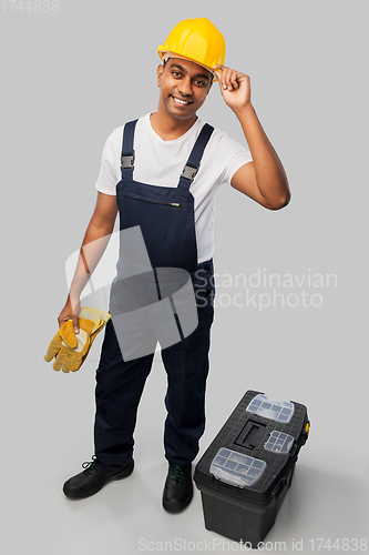 Image of happy indian builder in helmet with tool box