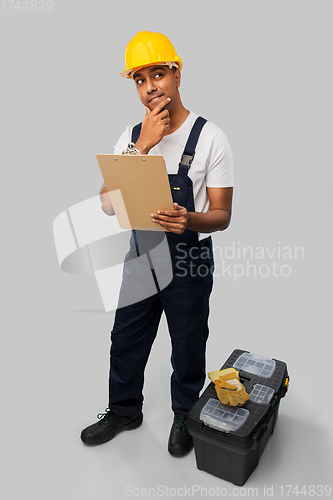 Image of builder with clipboard and tool box thinking