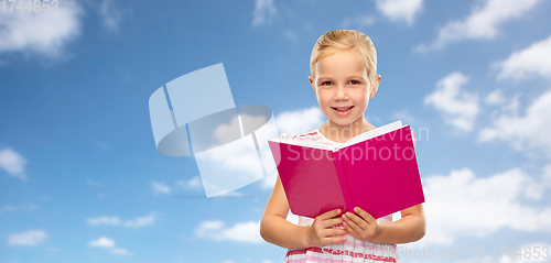 Image of smiling little girl reading book