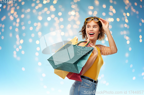 Image of happy smiling young woman with shopping bags