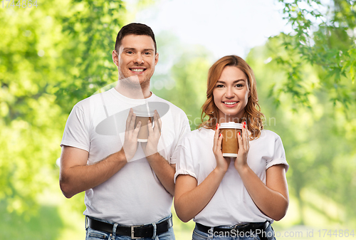 Image of portrait of happy couple with takeaway coffee cups